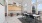 Large, open room with big windows in the coffee lounge with 6 seater dining table and 3 banquet seating tables on the back wall