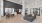 Leasing Office with grey couch in the center of the room and leasing desks on the back right wall