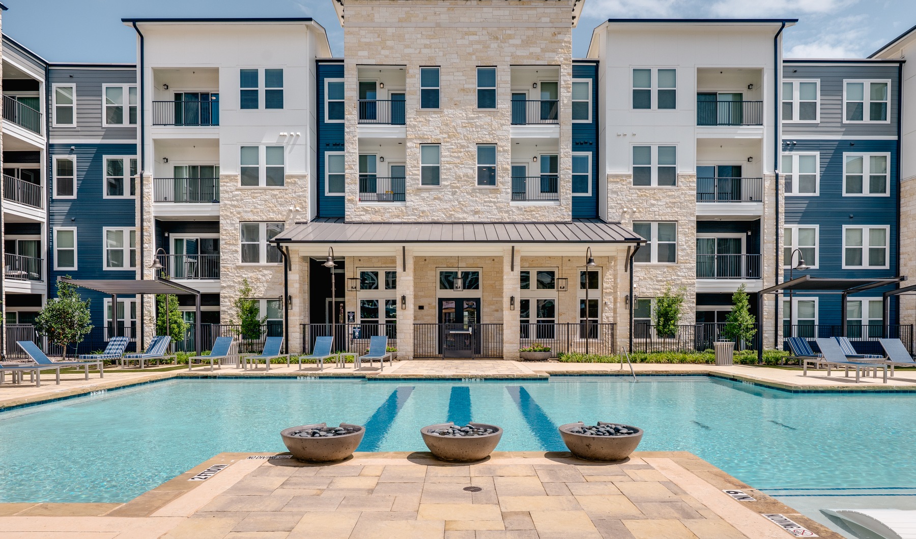Grove Pool centered photo of pool with apartment building in background